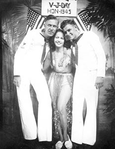 Earl "Jitterbug" Pearson and Herman Toscano celebrate the end of the war by having their photograph taken with a Hotel Street hostess. Earl 'Jitterbug' Pearson and Herman Toscano celebrate the end of the war by having their photograph taken with a Hotel Street hostess.