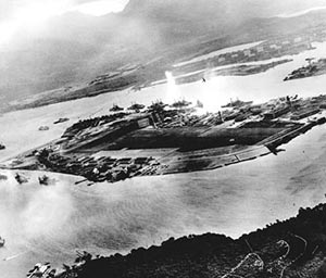 Captured Japanese photograph of attack on Pearl Harbor 7 December 1941.  Looking from west to east across Ford Field.  Note explosion from airplane departing over battleship row.  (US Navy photo)