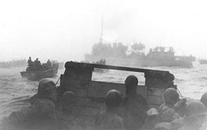 World War I vintage 'four stacker' destroyer USS Pruitt (DM 22) leads landing craft to fog-shrouded invasion beaches of Attu on 11 May 1943.  (US Navy photograph)